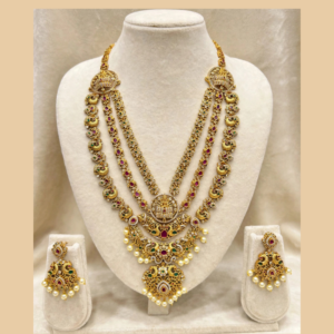 Gold-Plated Lakshmi Devi 3-Layer Long Haram Necklace Set with White CZ, Ruby Pink & Emerald Green Stones and Pearl Drops - With Matching Earrings